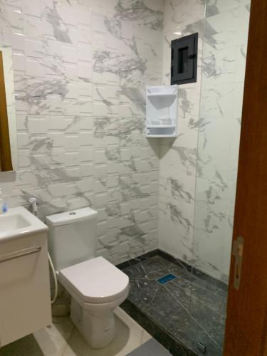 a bathroom with a toilet and a sink at bel appartement juste à côté de McDonald's in Kenitra
