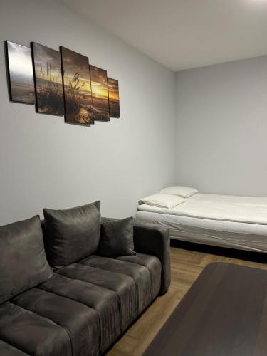 a living room with a couch and a bed at Kerulis Apartments in Vilnius