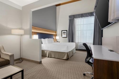 a hotel room with a bed and a window at Best Western Plus Revelstoke in Revelstoke