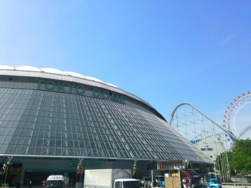 a building with a roller coaster in the background at Hotel Villa Fontaine Tokyo-Kudanshita in Tokyo