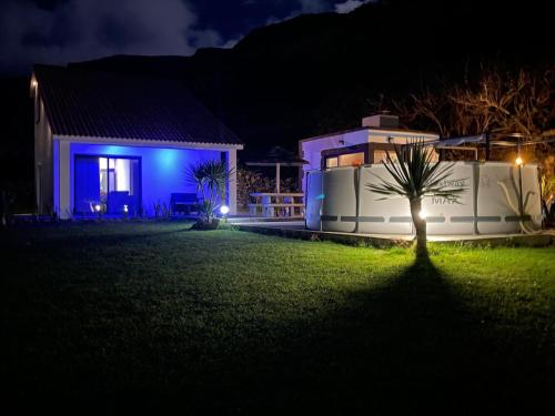 a house with a tree in the yard at night at Spot Milasmar in Faja Grande