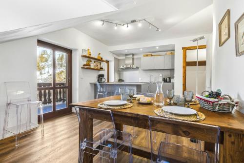 a kitchen with a large wooden table with chairs at Hostdomus - Inside Alps Suite in Cesana Torinese