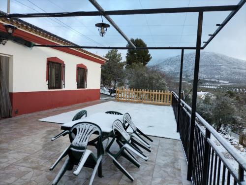 a table and chairs on the patio of a house at El Almendro de Fuentes Nuevas in Castril