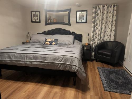 a bedroom with a bed with a dog pillow and a chair at The Hillside Hottie! in Corydon
