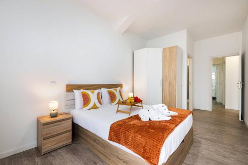 a bedroom with a bed with two stuffed animals on it at Sol Blessing by GALMI in Ponta do Sol