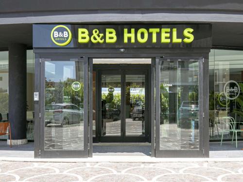 an entrance to a hotel with two revolving doors at B&B HOTEL Latina in Latina