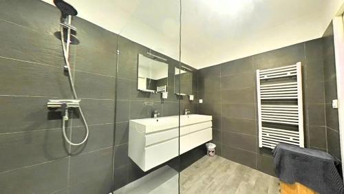 a bathroom with a sink and a shower at L'Immortelle in Zonza