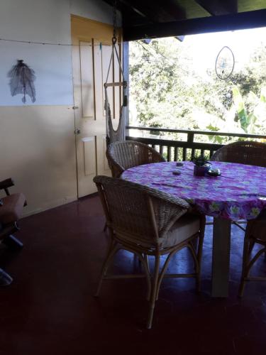 a purple table and chairs in a room with a window at Villa Mar Sosua in Sosúa