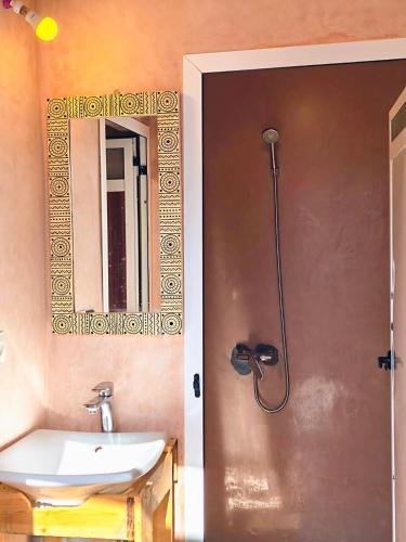 a bathroom with a sink and a shower at SURF TRIP ROOM IN OUASSANe in Essaouira