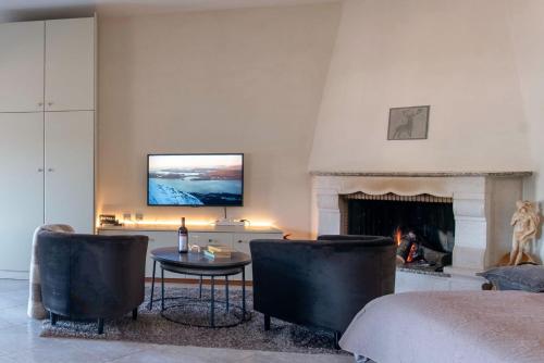 a living room with a bed and a fireplace at Lakeview Balcony in Kastoria in Kastoria