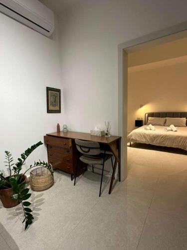 a bedroom with a desk and a bed at The Hidden Mint - Valletta in Valletta
