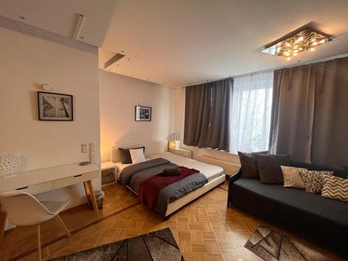 a bedroom with a bed and a desk and a couch at Grosses Apartment Aschaffenburg 4 Schlafzimmer für bis zu 11 Gäste AschaffApartment Mainaschaff in Mainaschaff
