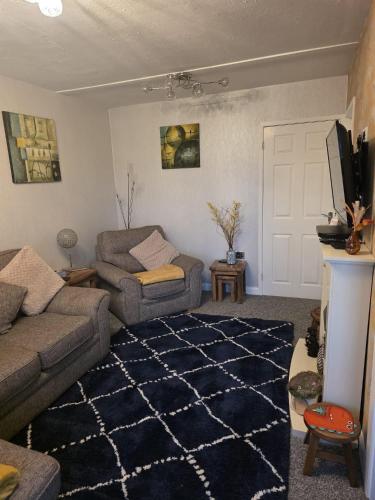 a living room with a couch and a tv at Pet friendly sleeps 6 Chalet Bridlington free elec in Bridlington