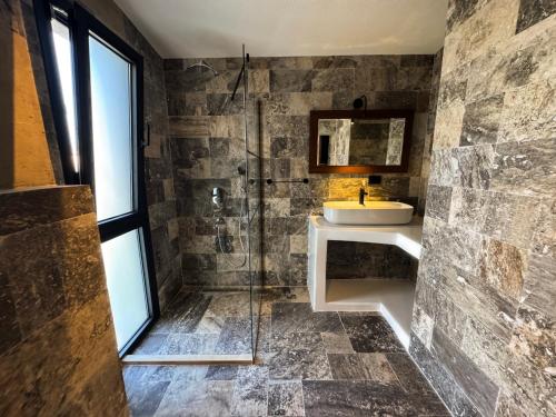 a bathroom with a sink and a shower at Villa Peri Alacati in Alaçatı
