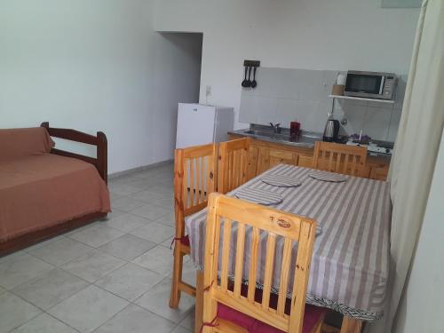 a kitchen with a table and a table and a couch at Bienvenidos viajeros in Chajarí