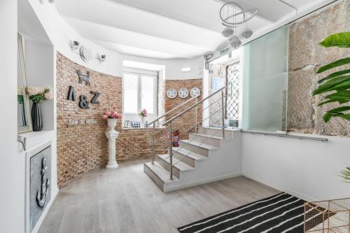 a room with a staircase and a brick wall at AYZ Juan de Mena - Auto check-in property in Madrid
