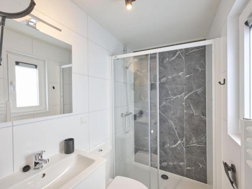 a bathroom with a shower and a sink at Steltloper in Nunspeet