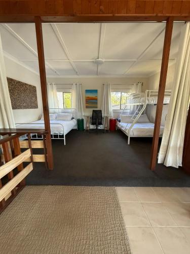 a bedroom with two bunk beds in a tent at Terrigal Cottage in Terrigal