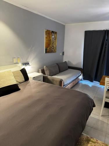 a hotel room with a bed and a couch at DINASTIE PALACE in Chajarí