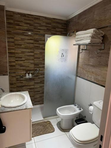 a bathroom with a toilet and a sink and a shower at DINASTIE PALACE in Chajarí