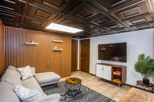 a living room with a couch and a tv at Stylish Garden-Level 2BR: Quiet Neighborhood in Chicago