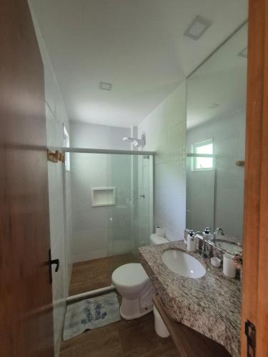 a bathroom with a toilet and a sink and a shower at Paraíso em Imbassaí in Imbassai