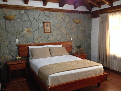 Postel nebo postele na pokoji v ubytování Hotel y Hosteria Natabuela