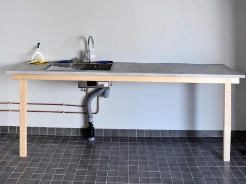a wooden table with a sink in a room at 6 person holiday home in Dyrvik in Dyrvik