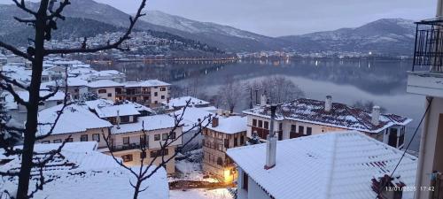 a view of a town with snow covered buildings and a lake at Lakeview Balcony in Kastoria in Kastoria