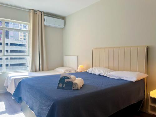 a bedroom with two beds with a stuffed animal on the bed at AP Smart Center in Campinas