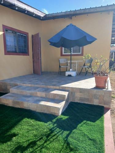a patio with a table and an umbrella at Sunny Isle Apartment in Rooi Master