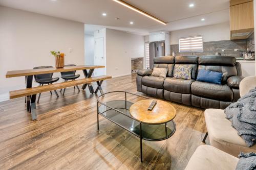 a living room with a couch and a table at Boutique Hillside Heaven near AKLD Airport in Auckland