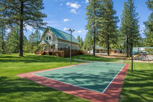 a tennis court in front of a house at Recharge by The River by NW Comfy Cabins in Leavenworth