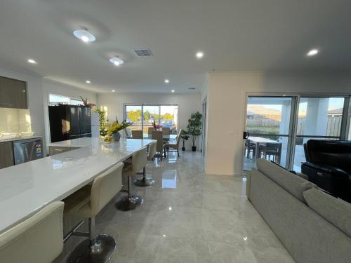 a kitchen and living room with a counter and a couch at Ensuite room in Mount Duneed in Mount Duneed