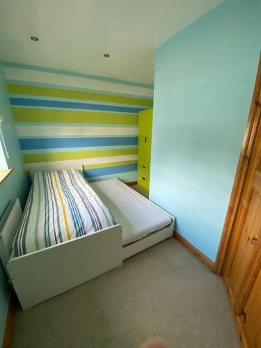 a small room with a bed in the corner at Rockside Villa Cashel Sleeps 6, Jacuzzi Bath, Walk to Rock of Cashel in Cashel