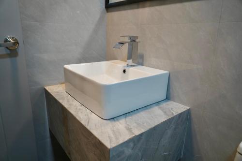 a white sink sitting on a counter in a bathroom at Havaa Inn Dhangethi in Dhangethi