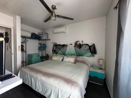 a bedroom with a bed and a ceiling fan at Marineros Vallarta in Puerto Vallarta