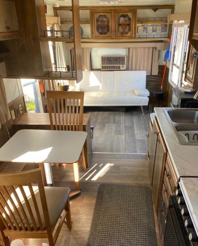 a kitchen and living room of an rv at Cozy Private 5th Wheel AC Pet Friendly in Tucson