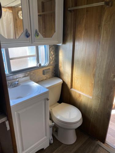 a small bathroom with a toilet and a sink at Cozy Private 5th Wheel AC Pet Friendly in Tucson