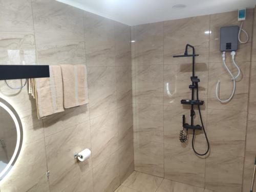 a bathroom with a shower with a glass shower at Orange House in San Juan