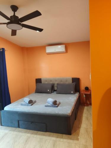 a bedroom with a bed with two people on it at Orange House in San Juan
