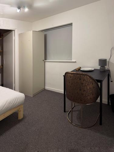 a bedroom with a desk and a chair and a bed at Valley house in Nottingham