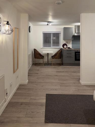 a living room with a table and chairs and a kitchen at Valley house in Nottingham