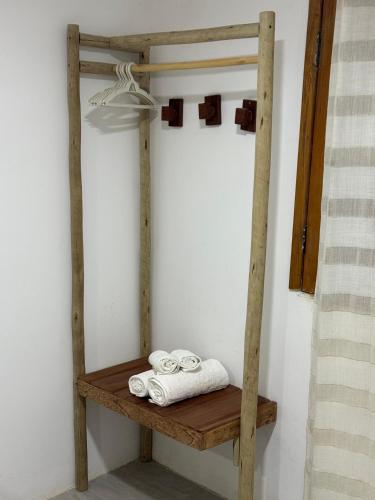 a wooden shelf with towels on it in a room at Casa Aura Solis Preá in Prea