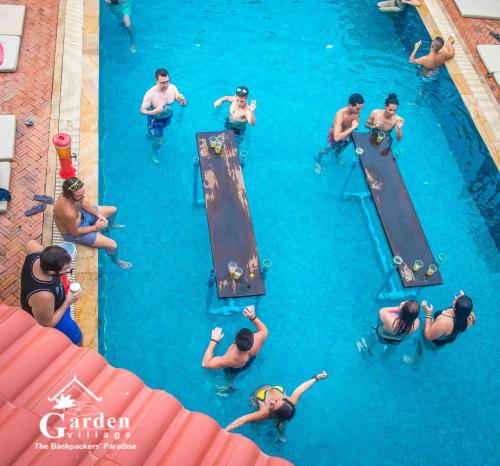 a group of people in the water at a swimming pool at Garden Village Guesthouse & Pool Bar in Siem Reap