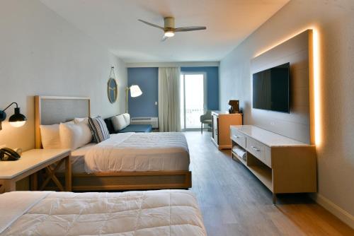 a hotel room with two beds and a television at Rod 'N' Reel Resort in Chesapeake Beach