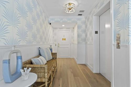 a hallway with a couch and a table in a room at Boutique condo w oceanfront & concierge in Palm Beach