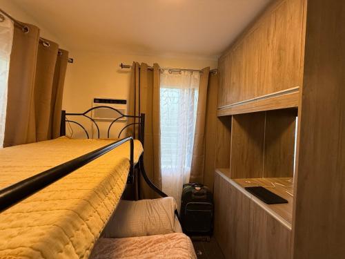 a small bedroom with a bed and a closet at Bungalow small peaceful house in Daanbantayan