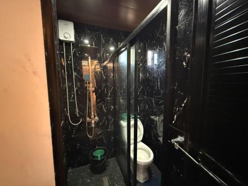 a bathroom with a stall with a toilet in it at Bungalow small peaceful house in Daanbantayan