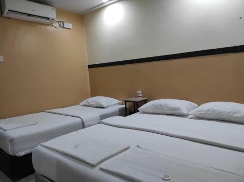 a room with two beds in a room at House 11 in Lahad Datu
